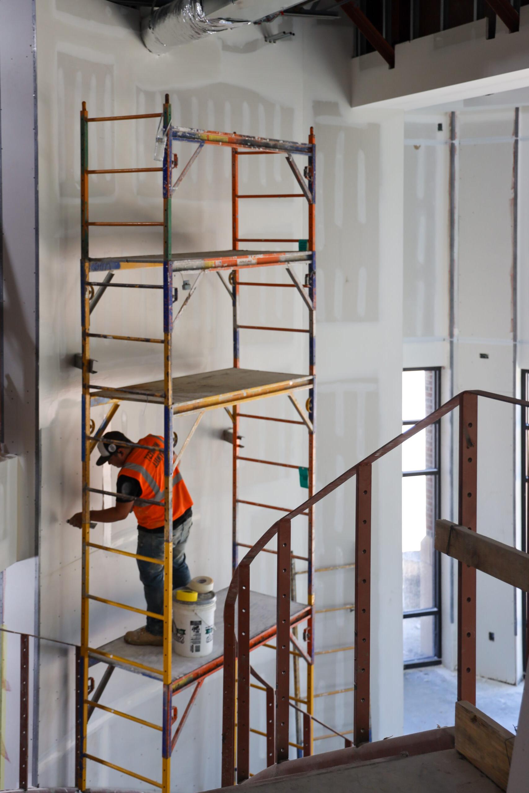 Construction work, man near scaffold